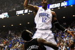 ORLANDO, FL - APRIL 28: Dwight Howard #12 of the Orlando Magic shoots over Samuel Dalembert #1 of the Philadelphia 76ers in Game Five of the Eastern Conference Quarterfinals during the 2009 NBA Playoffs at Amway Arena on April 28, 2009 in Orlando, Florida. NOTE TO USER: User expressly acknowledges and agrees that, by downloading and/or using this Photograph, user is consenting to the terms and conditions of the Getty Images License Agreement.  (Photo by Sam Greenwood/Getty Images)