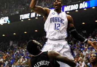 ORLANDO, FL - APRIL 28: Dwight Howard #12 of the Orlando Magic shoots over Samuel Dalembert #1 of the Philadelphia 76ers in Game Five of the Eastern Conference Quarterfinals during the 2009 NBA Playoffs at Amway Arena on April 28, 2009 in Orlando, Florida. NOTE TO USER: User expressly acknowledges and agrees that, by downloading and/or using this Photograph, user is consenting to the terms and conditions of the Getty Images License Agreement.  (Photo by Sam Greenwood/Getty Images)