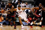 ATLANTA - APRIL 22:  Jermaine O'Neal #7 of the Miami Heat takes the ball away from Joe Johnson #2 of the Atlanta Hawks as Dwyane Wade #3 runs up-court during Game Two of the Eastern Conference Quarterfinals at Philips Arena on April 22, 2009 in Atlanta, Georgia. NOTE TO USER: User expressly acknowledges and agrees that, by downloading and/or using this Photograph, user is consenting to the terms and conditions of the Getty Images License Agreement.  (Photo by Doug Benc/Getty Images)