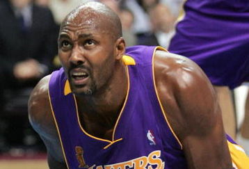 AUBURN HILLS, MI - JUNE 10:  Karl Malone #11 of the Los Angeles Lakers reacts after a play against the Detroit Pistons during the second quarter of game three of the 2004 NBA Finals June 10, 2004 at The Palace of Auburn Hills in Auburn Hills, Michigan.  NOTE TO USER: User expressly acknowledges and agrees that, by downloading and or using this photograph, User is consenting to the terms and conditions of the Getty Images License Agreement.  (Photo by Jed Jacobsohn/Getty Images)