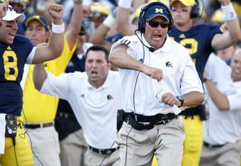 ANN ARBOR, MI - AUGUST 30:  Head coach Rich Rodriguez of the Michigan Wolverines reacts after a fourth quarter touchdown in front of Nick Sheridan #8, Mike Barwis and David Cone #12 while playing the Utah Utes on August 30, 2008 at Michigan Stadium in Ann Arbor, Michigan. Utah won the game 25-23.  (Photo by Gregory Shamus/Getty Images)