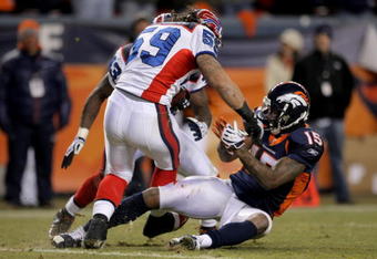 DENVER - DECEMBER 21:  Linebacker Kawika Mitchell #59 of the Buffalo Bills makes an interception of a Jay Culter pass late in the fourth quarter as intended receiver Brandon Marshall #15 of the Denver Broncos makes the tackle on the two yard line at Invesco Field at Mile High on December 21, 2008 in Denver, Colorado. The Bills defeated the Broncos 30-23.  (Photo by Doug Pensinger/Getty Images)
