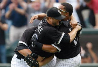 CHICAGO, IL - JULY 23: Pitcher Mark Buehrle #56 of the Chicago White Sox celebrates after pitching a perfect game as he is grabbed by first baseman Josh Fields #7 and catcher Ramon Castro #27 against the Tampa Bay Rays at U.S. Cellular Field on July 23, 2009 in Chicago, Illinois. The White Sox defeated the Rays 5-0. (Photo by Scott Boehm/Getty Images)