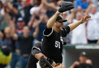 CHICAGO, IL - JULY 23: Pitcher Mark Buehrle #56 of the Chicago White Sox celebrates after pitching a perfect game as he is grabbed by first baseman Josh Fields #7 against the Tampa Bay Rays at U.S. Cellular Field on July 23, 2009 in Chicago, Illinois. The The White Sox defeated the Rays 5-0. (Photo by Scott Boehm/Getty Images)
