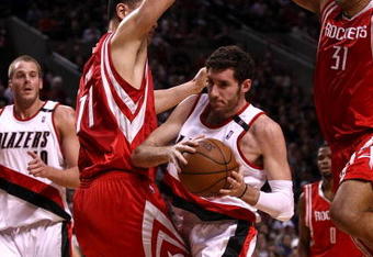 PORTLAND, OR - APRIL 28:  Rudy Fernandez #5 of the Portland Trail Blazers drives against Yao Ming #11 and Shane Battier #31 of the Houston Rockets during Game 5 of the Western Conference Quarterfinals of the NBA Playoffs on April 28, 2009 at the Rose Garden in Portland, Oregon. NOTE TO USER: User expressly acknowledges and agrees that, by downloading and or using this Photograph, user is consenting to the terms and conditions of the Getty Images License Agreement.  (Photo by Jonathan Ferrey/Getty Images)