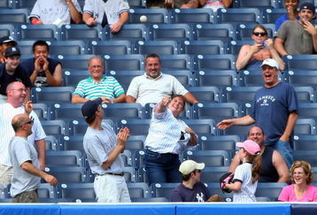 NEW YORK - JULY 22:  A fan throws back a home run ball hit by the Baltimore Orioles in the ninth against the New York Yankees of the  on July 22, 2009 at Yankee Stadium in the Bronx borough of New York City. The Yankees defeated the Orioles 6-4.  (Photo by Jim McIsaac/Getty Images)