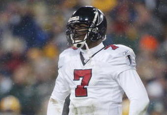 GREEN BAY, WI - JANUARY 4:  Michael Vick #7 of the Atlanta Falcons looks on against the Green Bay Packers during the NFC Wildcard game at Lambeau Field on January 4, 2003 in Green Bay, Wisconsin.  The Falcons won 27-7.  (Photo by Jonathan Daniel/Getty Images)