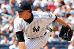 NEW YORK - JULY 22:  Phil Hughes #65 of the New York Yankees pitches against the Baltimore Orioles on July 22, 2009 at Yankee Stadium in the Bronx borough of New York City.  (Photo by Jim McIsaac/Getty Images)