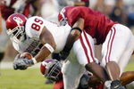 TUSCALOOSA, AL - SEPTEMBER 6: James Moses #89 of the Oklahoma Sooners is tackled by Derrick Pope #6 and DeMeco Ryans #35 of the Alabama Crimson Tide on September 6, 2003 in Tuscaloosa, Alabama. Oklahoma defeated Alabama 20-13. (Photo by Jamie Squire/Getty Images). 
