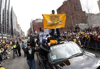 PITTSBURGH - FEBRUARY 03: Ryan Clark #25 of the Pittsburgh Steelers sands on top of his truck with a Terrible Towel during a parade to celebrate winning Super Bowl XLIII on February 3, 2009 in Pittsburgh, Pennsylvania.  (Photo by Gregory Shamus/Getty Images)