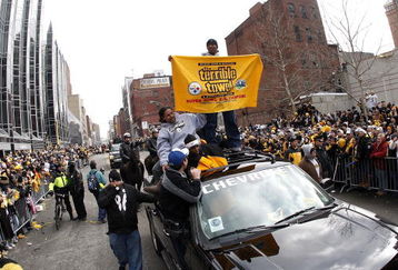 PITTSBURGH - FEBRUARY 03: Ryan Clark #25 of the Pittsburgh Steelers sands on top of his truck with a Terrible Towel during a parade to celebrate winning Super Bowl XLIII on February 3, 2009 in Pittsburgh, Pennsylvania.  (Photo by Gregory Shamus/Getty Images)