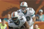 MIAMI, FL - JANUARY 4:  Quarterback Chad Pennington #10 of the Miami Dolphins takes a snap from center Samson Satele #64 against the Baltimore Ravens in an NFL Wildcard Playoff Game at Dolphins Stadium on January 4, 2009 in Miami, Florida.  (Photo by Al Messerschmidt/Getty Images) 