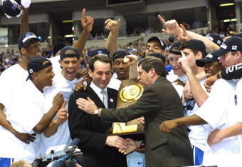 2 Apr 2001:  Head coach Mike Krzyzewski of Duke is presented with the trophy after defeating Arizona 82-72 in the NCAA National Championship Game of the Men's Final Four tournament at the Metrodome in Minneapolis, Minnesota.  DIGITAL IMAGE. Mandatory Credit: Brian Bahr/ALLSPORT