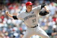 NEW YORK - JULY 04:  Roy Halladay #32 of the Toronto Blue Jays pitches against the New York Yankees on July 4, 2009 at Yankee Stadium in the Bronx borough of New York City.  (Photo by Nick Laham/Getty Images)