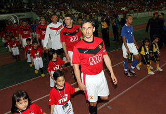 KUALA LUMPUR, MALAYSIA - JULY 20: Manchester United and Malaysia XI march into the pitch before kick off during the pre-season friendly match between Manchester United and Malaysia XI at Bukit Jalil National Stadium on July 20, 2009 in Kuala Lumpur, Malaysia. (Photo by Stanley Chou/Getty Images)