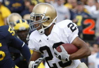 ANN ARBOR, MI - SEPTEMBER 15:  Golden Tate #23 of the Notre Dame Fighting Irish tries to turn the corner in front of Brandon Graham #55 of Michigan Wolverines at Michigan Stadium September 15, 2007 in Ann Arbor, Michigan. Michigan won the game 38-0.  (Photo by Gregory Shamus/Getty Images)