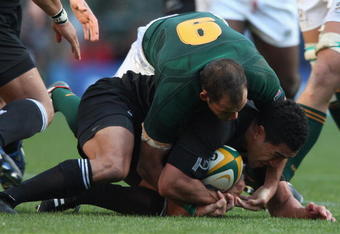 CAPE TOWN, SOUTH AFRICA - AUGUST 16:  Mils Muliaina of New Zealand is held by Fourie du Preez during the 2008 Tri Nations match between the South Africa Springboks and the New Zealand All Blacks at Newlands on August 16, 2008 in Cape Town, South Africa.  (Photo by David Rogers/Getty Images)