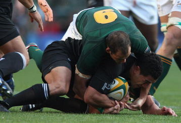 CAPE TOWN, SOUTH AFRICA - AUGUST 16:  Mils Muliaina of New Zealand is held by Fourie du Preez during the 2008 Tri Nations match between the South Africa Springboks and the New Zealand All Blacks at Newlands on August 16, 2008 in Cape Town, South Africa.  (Photo by David Rogers/Getty Images)