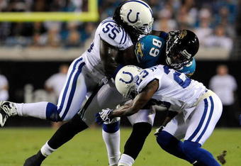 JACKSONVILLE, FL - DECEMBER 18:  Marcedes Lewis #89 of the Jacksonville Jaguars is tackled by Clint Session #55 and Tim Jennings #23 of the Indianapolis Colts during the game at Jacksonville Municipal Stadium on December 18, 2008 in Jacksonville, Florida.  (Photo by Sam Greenwood/Getty Images)