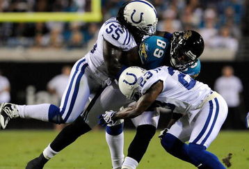 JACKSONVILLE, FL - DECEMBER 18:  Marcedes Lewis #89 of the Jacksonville Jaguars is tackled by Clint Session #55 and Tim Jennings #23 of the Indianapolis Colts during the game at Jacksonville Municipal Stadium on December 18, 2008 in Jacksonville, Florida.  (Photo by Sam Greenwood/Getty Images)