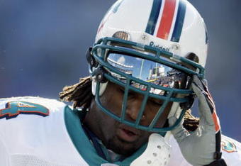 FOXBORO, MA - DECEMBER 29:  Ricky Williams #34 of the Miami Dolphins lifts his helmet during the game against the New England Patriots at Gillette Stadium on December 29, 2002 in Foxboro, Massachusetts. The Patriots defeated the Dolphins 27-24 in overtime. (Photo by Ezra Shaw/Getty Images)