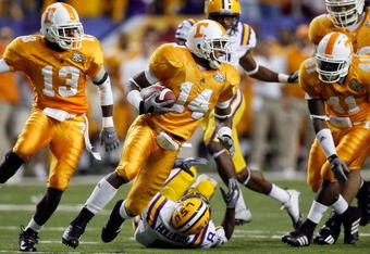 ATLANTA - DECEMBER 01: Eric Berry #14 of the University of Tennessee Volunteers runs with a fumble by Trindon Holliday #8 of the Louisiana State University Tigers in the SEC Championship game on December 1, 2007 at the Georgia Dome in Atlanta, Georgia.  The Tigers defeated the Volunteers 21-14.  (Photo by Chris Graythen/Getty Images)