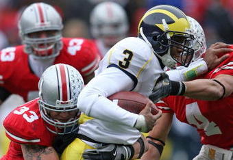 COLUMBUS, OH - NOVEMBER 22:  James Laurinaitis #33 and Kurt Coleman #4 of the Ohio State Buckeyes tackle Justin Feagin #3 of the Michigan Wolverines during the Big Ten Conference game at Ohio Stadium on November 22, 2008 in Columbus, Ohio.  (Photo by Andy Lyons/Getty Images)