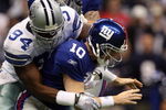 IRVING, TX - DECEMBER 14:  Quarterback Eli Manning #10 of the New York Giants fumbles the ball while sacked by DeMarcus Ware #94 of the Dallas Cowboys in the first quarter at Texas Stadium on December 14, 2008 in Irving, Texas.  (Photo by Ronald Martinez/Getty Images)