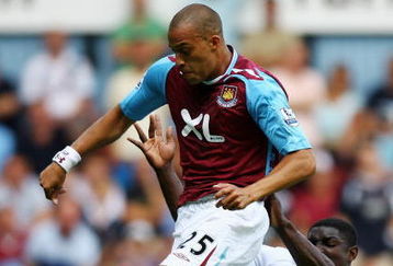LONDON - AUGUST 11:  Micah Richards of Manchester City tackles Bobby Zamora of West Ham during the Barclays Premiership match between West Ham United and Manchester City at Upton Park on August 11, 2007 in London, England.  (Photo by Ryan Pierse/Getty Images)
