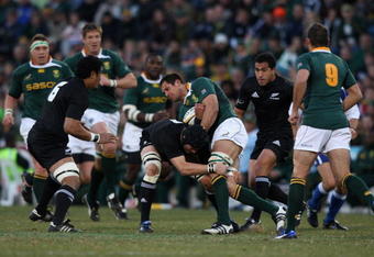 BLOEMFONTEIN, SOUTH AFRICA - JULY 25:  Pierre Spies of South Africa is tackled by Richie McCaw during the 2009 Tri Nations match between South Africa and the New Zealand All Blacks at Vodacom Park on July 25, 2009 in Bloemfontein, South Africa.  (Photo by David Rogers/Getty Images)