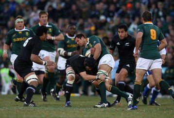 BLOEMFONTEIN, SOUTH AFRICA - JULY 25:  Pierre Spies of South Africa is tackled by Richie McCaw during the 2009 Tri Nations match between South Africa and the New Zealand All Blacks at Vodacom Park on July 25, 2009 in Bloemfontein, South Africa.  (Photo by David Rogers/Getty Images)