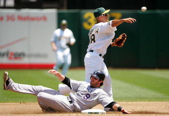 OAKLAND, CA - JUNE 28:  Ian Stewart #9 of the Colorado Rockies is out at second base but Orlando Cabrera #18 of the Oakland Athletics is unable to turn the double play and Troy Tulowitzki scored on the play to give the Rockies a 1-0 lead in the second inning of their game at the Oakland Coliseum on June 28, 2009 in Oakland, California.  (Photo by Ezra Shaw/Getty Images)