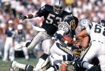 LOS ANGELES - SEPTEMBER 28:  Running back Lionel James #26 of the San Diego Chargers rushes for yards as linebacker Rod Martin #53 of the Los Angeles Raiders applies pressure during a game at the Los Angeles Memorial Coliseum on September 28, 1986 in Los Angeles, California.  The Raiders won 17-13.  (Photo by George Rose/Getty Images)