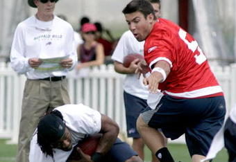 PITTSFORD, NY - JULY 25: Trent Edwards #5 of the Buffalo Bills hands off to Marshawn Lynch #23 who stubbles as head coach Dick Jauron watches during Training Camp on July 25, 2008 at Saint John Fisher College in Pittsford, New York.  (Photo by Rick Stewart/Getty Images)