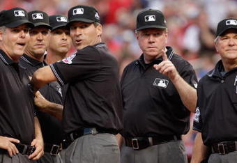 ST. LOUIS, MO - JULY 14:  2009 MLB All-Star Game umpires (l-r) Tim Timmons, Jeff Kellogg, Paul Nauert, Angel Hernandez, Brian Gorman and Dana DeMuth look on before the game at Busch Stadium on July 14, 2009 in St Louis, Missouri. (Photo by Jamie Squire/Getty Images)