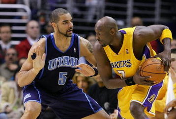 LOS ANGELES - JANUARY 17:  Carlos Boozer #5 of the Utah Jazz defends Lamar Odom #7 of the Los Angeles Lakers on January 17, 2005 at Staples Center in Los Angeles, California.  NOTE TO USER: User expressly acknowledges and agrees that, by downloading and or using this photograph, User is consenting to the terms and conditions of the Getty Images License Agreement.  (Photo by Lisa Blumenfeld/Getty Images)