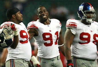 ATLANTA - OCTOBER 15:  Defensive tackle Barry Cofield #96, defensive end Justin Tuck #91 and defensive tackle Fred Robbins #98 of the New York Giants walk off the field after shutting down the offense of the Atlanta Falcons at Georgia Dome on October 15, 2007 in Atlanta, Georgia. The Giants defeated the Falcons 31-10 for their fourth straight win after opening the season 0-2.  (Photo by Doug Benc/Getty Images)