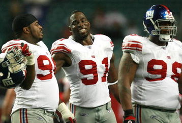 ATLANTA - OCTOBER 15:  Defensive tackle Barry Cofield #96, defensive end Justin Tuck #91 and defensive tackle Fred Robbins #98 of the New York Giants walk off the field after shutting down the offense of the Atlanta Falcons at Georgia Dome on October 15, 2007 in Atlanta, Georgia. The Giants defeated the Falcons 31-10 for their fourth straight win after opening the season 0-2.  (Photo by Doug Benc/Getty Images)