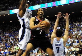 ORLANDO, FL - APRIL 28:  Andre Miller #7 of the Philadelphia 76ers attempts a shot over Dwight Howard #12 of the Orlando Magic in Game Five of the Eastern Conference Quarterfinals during the 2009 NBA Playoffs at Amway Arena on April 28, 2009 in Orlando, Florida. NOTE TO USER: User expressly acknowledges and agrees that, by downloading and/or using this Photograph, user is consenting to the terms and conditions of the Getty Images License Agreement.  (Photo by Sam Greenwood/Getty Images)