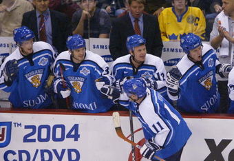 ST. PAUL, MN - SEPTEMBER 10:  Saku Koivu #11 of Team Finland is congratulated by teammates after scoring the game-winning goal against Team USA in the 2004 World Cup of Hockey semifinal game on September 10, 2004 at the Xcel Center in St. Paul, Minnesota.  Finland defeated the U.S. 2-1.  (Photo By Dave Sandford/Getty Images)