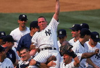 18 Jul 1999: David Cone #36 of the New York Yankees celebrates as his teammates lift him after winning the game against the Montreal Expos at Yankee Stadium in Bronx, New York. The Yankees defeated the Expos 6-0.