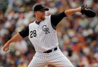DENVER - JULY 26:  Starting pitcher Aaron Cook #28 of the Colorado Rockies delivers against the San Francisco Giants at Coors Field on July 26, 2009 in Denver, Colorado.  (Photo by Doug Pensinger/Getty Images)