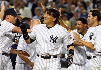 NEW YORK - JULY 20:  Hideki Matsui #55 (R) of the New York Yankees celebrates his game winning ninth inning home run against the Baltimore Orioles with his teammates on July 20, 2009 at Yankee Stadium in the Bronx borough of New York City. The Yankees defeated the Orioles 2-1.  (Photo by Jim McIsaac/Getty Images)