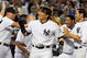 NEW YORK - JULY 20: Hideki Matsui #55 (R) of the New York Yankees celebrates his game winning ninth inning home run against the Baltimore Orioles with his teammates on July 20, 2009 at Yankee Stadium in the Bronx borough of New York City. The Yankees defeated the Orioles 2-1. (Photo by Jim McIsaac/Getty Images)