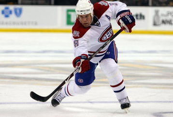 BOSTON - APRIL 16:  Mike Komisarek #8 of the Montreal Canadiens passes the puck against the Boston Bruins during Game 1 of the Eastern Conference quarterfinals of the 2009 Stanley Cup playoffs on April 16, 2009 at the TD Banknorth Garden in Boston, Massachusetts.  (Photo by Elsa/Getty Images)