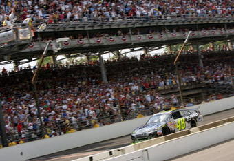 INDIANAPOLIS - JULY 26:  Jimmie Johnson, driver of the #48 Lowe's/KOBALT Tools Chevrolet, crosses the finish line to win the NASCAR Sprint Cup Series Allstate 400 at the Brickyard at Indianapolis Motor Speedway on July 26, 2009 in Indianapolis, Indiana.  (Photo by Ezra Shaw/Getty Images)