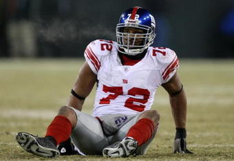 GREEN BAY, WI - JANUARY 20:  Defensive end Osi Umenyiora #72 of the New York Giants sits on the turf during the NFC championship game against the Green Bay Packers on January 20, 2008 at Lambeau Field in Green Bay, Wisconsin.  (Photo by Jed Jacobsohn/Getty Images)