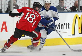 TORONTO - APRIL 11:  Christian Hanson #20 of the Toronto Maple Leafs chases skates around Jesse Winchester #18 of the Ottawa Senators in a game on April 11, 2009 at the Air Canada Centre in Toronto, Ontario. The Leafs defeated the Senators on the strength of a 3 goal performance by Boyd Devereaux #22. (Photo by Claus Andersen/Getty Images)