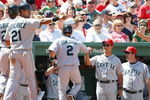 BOSTON - JULY 05:  Ken Griffey Jr #24, Franklin Gutierrez #21 and Kenji Johjima #2 of the Seattle Mariners are congratulated by teammates in the dugout after scoring in the fourth inning against the Boston Red Sox on July 5, 2009 at Fenway Park in Boston, Massachusetts.  (Photo by Elsa/Getty Images)
