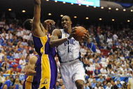 ORLANDO, FL - JUNE 14:  Dwight Howard #12 of the Orlando Magic moves through the lane against Andrew Bynum #17 of the Los Angeles Lakers in Game Five of the 2009 NBA Finals on June 14, 2009 at Amway Arena in Orlando, Florida. The Lakers won 99-86.  NOTE TO USER:  User expressly acknowledges and agrees that, by downloading and or using this photograph, User is consenting to the terms and conditions of the Getty Images License Agreement. (Photo by Ronald Martinez/Getty Images) 
